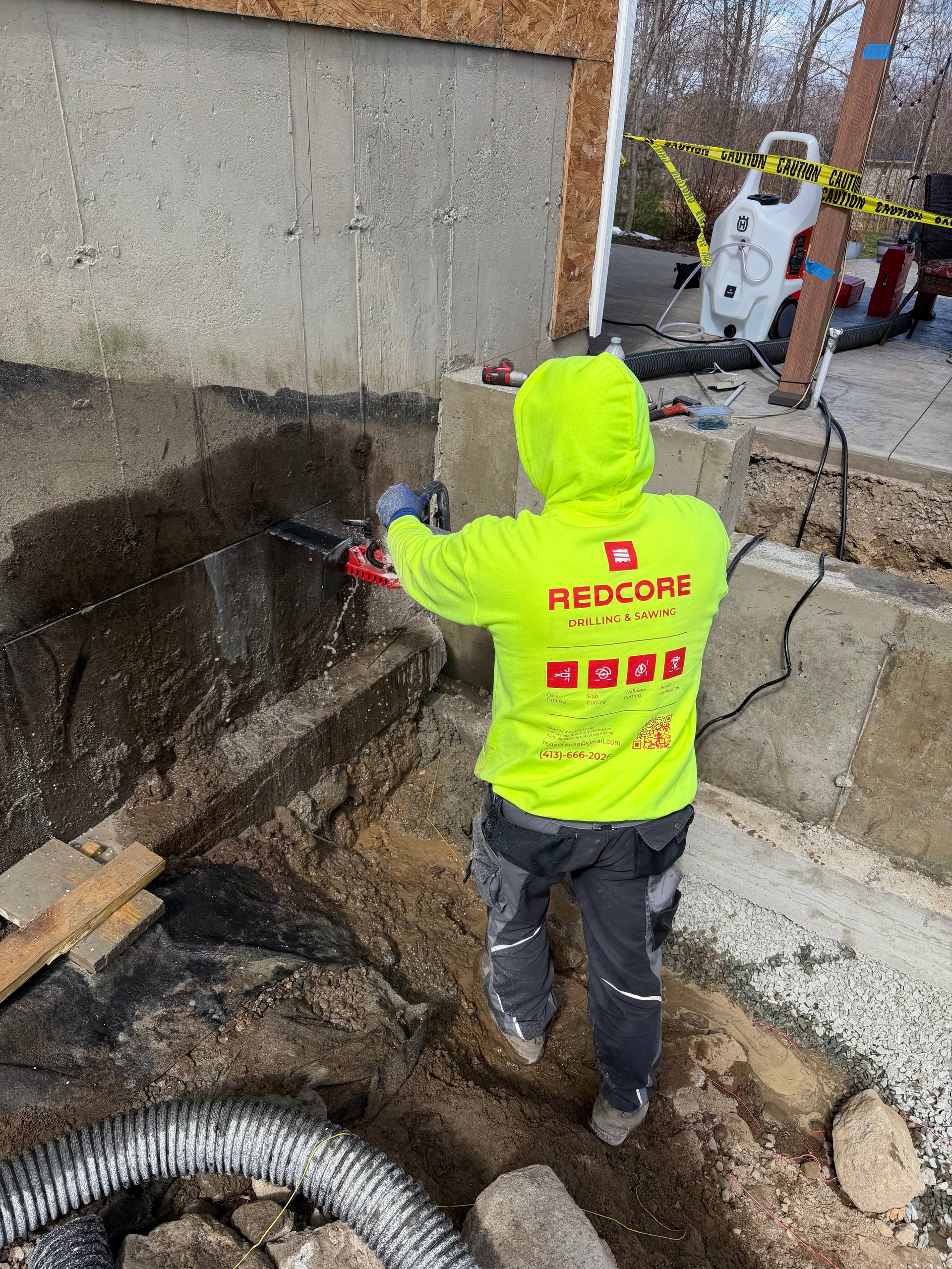 Hand saw cutting concrete wall